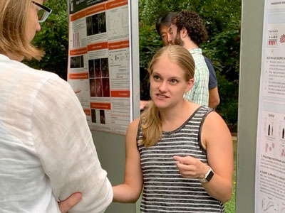 UVA Cell and Molecular biology grad student explaining her poster to a colleague.