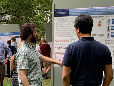 UVA Cell and Molecular Biology grad students viewing posters at a poster session on the UVA grounds.