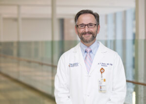 Dr. James Nataro, Dept. of Pediatrics in white coat
