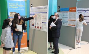 mulitple people looking at research posters
